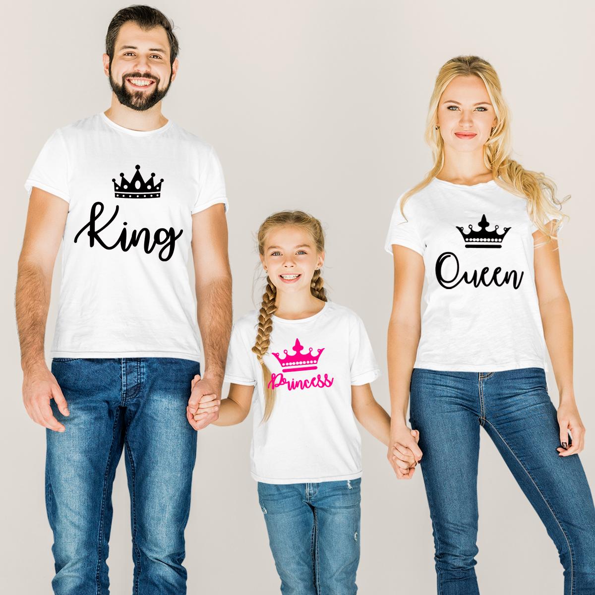 Set de trei tricouri albe pentru familie cu imprimeu grafic negru și roz: King pentru tată, Queen pentru mamă și Princess pentru fiică, purtate de o familie zâmbitoare.